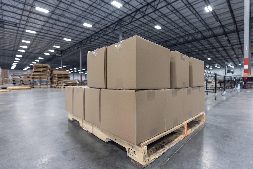 Boxes stacked onto a pallet in a warehouse