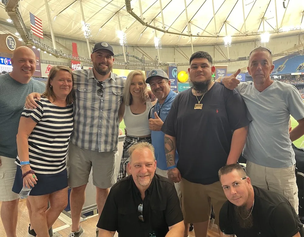 WeShip team members posing for a photo in a regional sports facility.